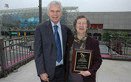 Bill Taylor and Ellen Marsden standing together with an award plaque